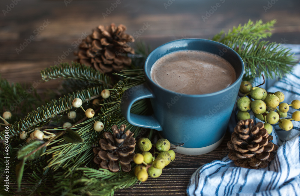 Mug of hot chocolate on wooden table with pine cones and boughs. Mug of hot chocolate on wooden table with pine cones and boughs.
