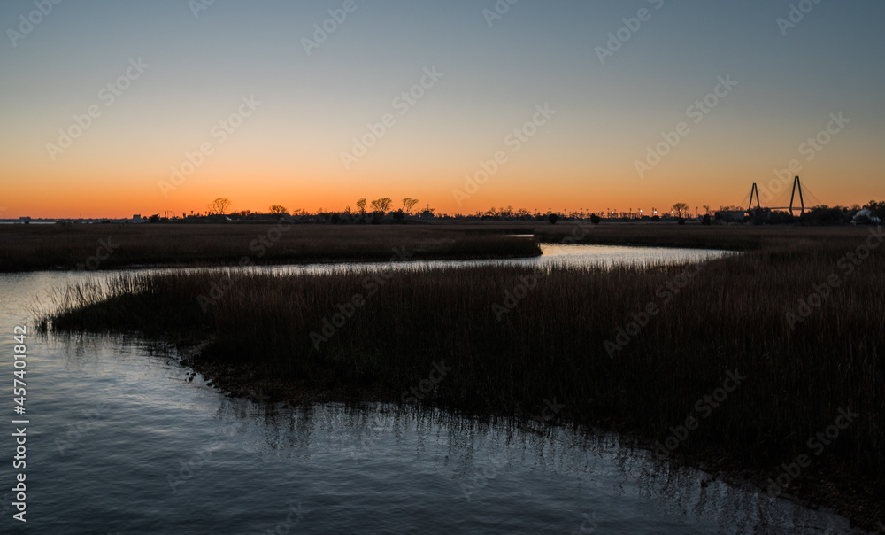 Naklejka premium sunset over the marsh charleston bridge