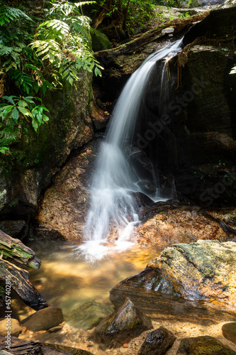 Beautiful view to rocky waterfall on green rainforest