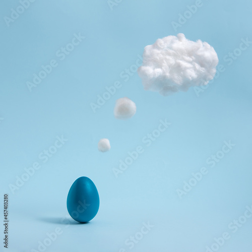 Blue Easter egg thinking on pastel blue background. Comic book motive