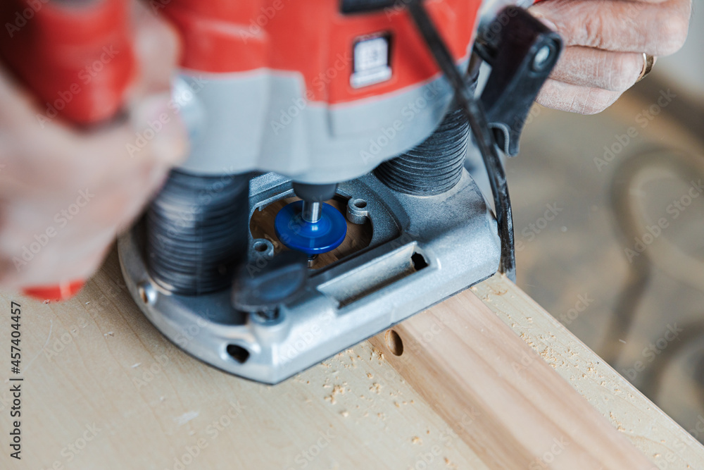 Carpenter's hands hold an electric planer Woodwork close view Carpenter's hands hold an electric planer Woodwork close view