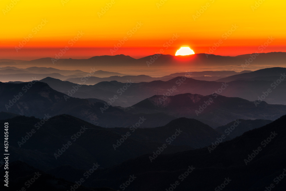 Red sun in the end of mountain range