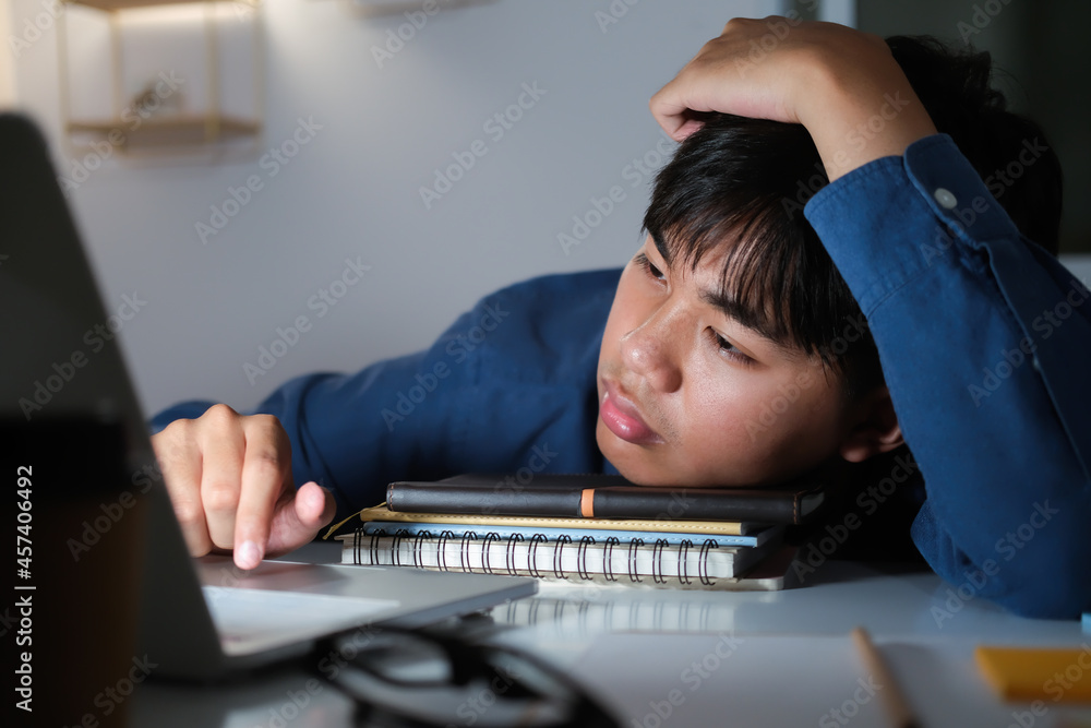 Sleepy exhausted collage young man working overtime. Sleepy exhausted collage young man working overtime.