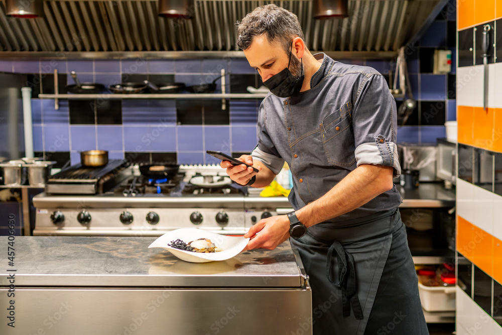fabulous kitchen chef photographing his plate fabulous kitchen chef photographing his plate