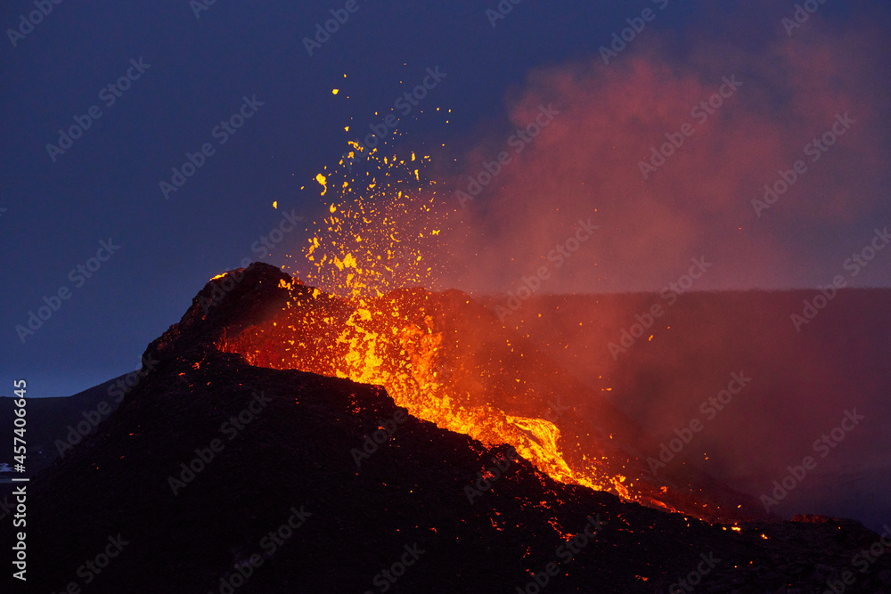 Active erupting volcano at night
