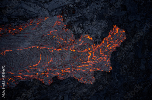 Volcanic lava flowing on rough slope