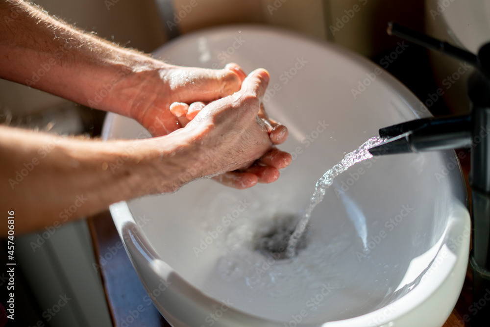 persoal hygiene, a man washing hands in the sink persoal hygiene, a man washing hands in the sink