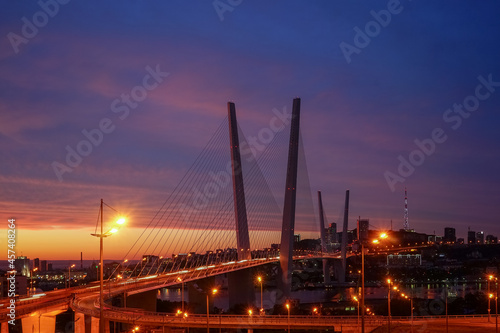 Golden bridge on the background of the magnificent dramatic sky at sunset