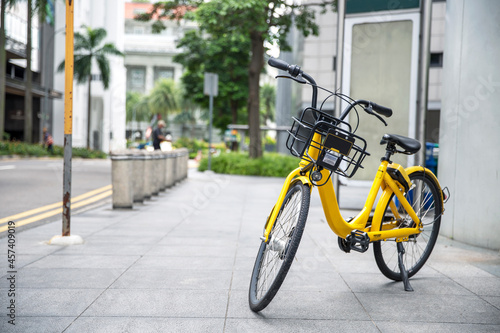 Yellow bike in public park building background and view landscap