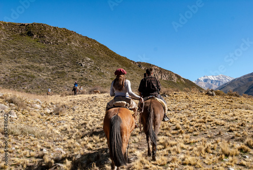 Dos personas disfrutando de cabalgata en la montaña de Mendoza photo