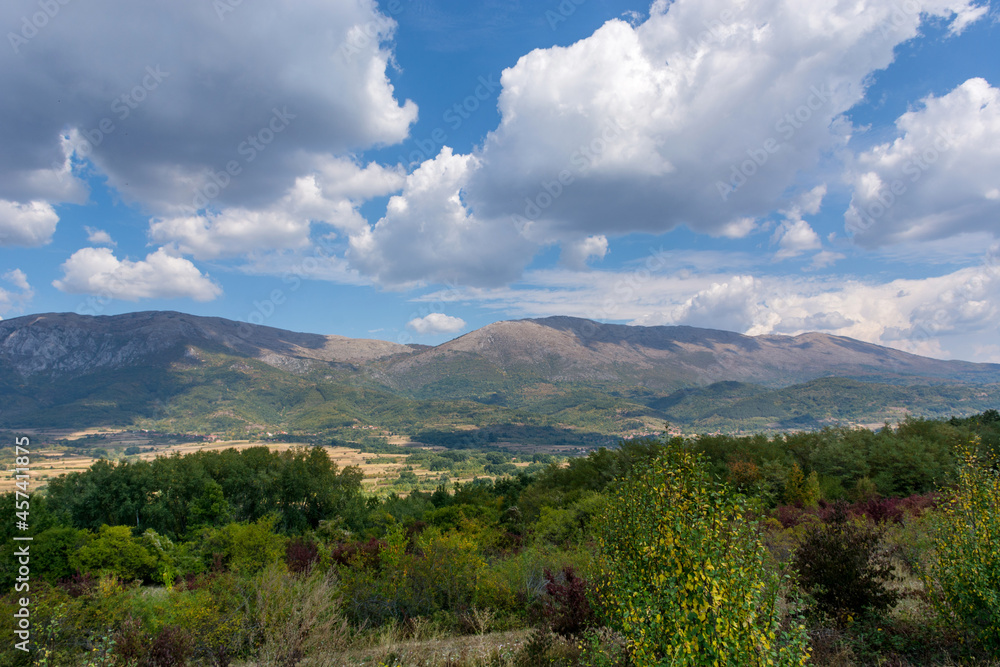 Landscape view of Suva Planina (The dry mountain) in Serbia on an autumn day. White clouds cast a shadow on the great mountain Landscape view of Suva Planina (The dry mountain) in Serbia on an autumn day. White clouds cast a shadow on the great mountain