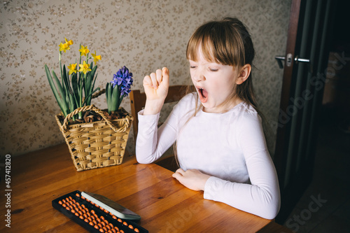 girl learning to count on abacus photo