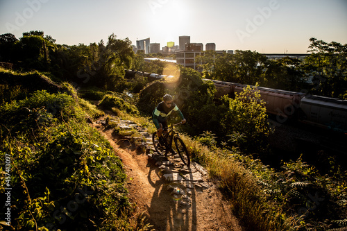 Mountain biker at sunrise with Richmond skyline in the background.