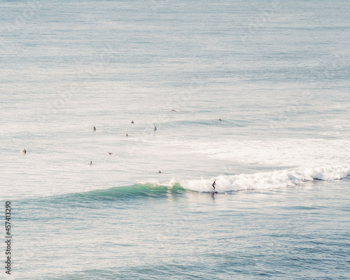 Photography Landscape of a group of people surfing on the sea on a sunny day