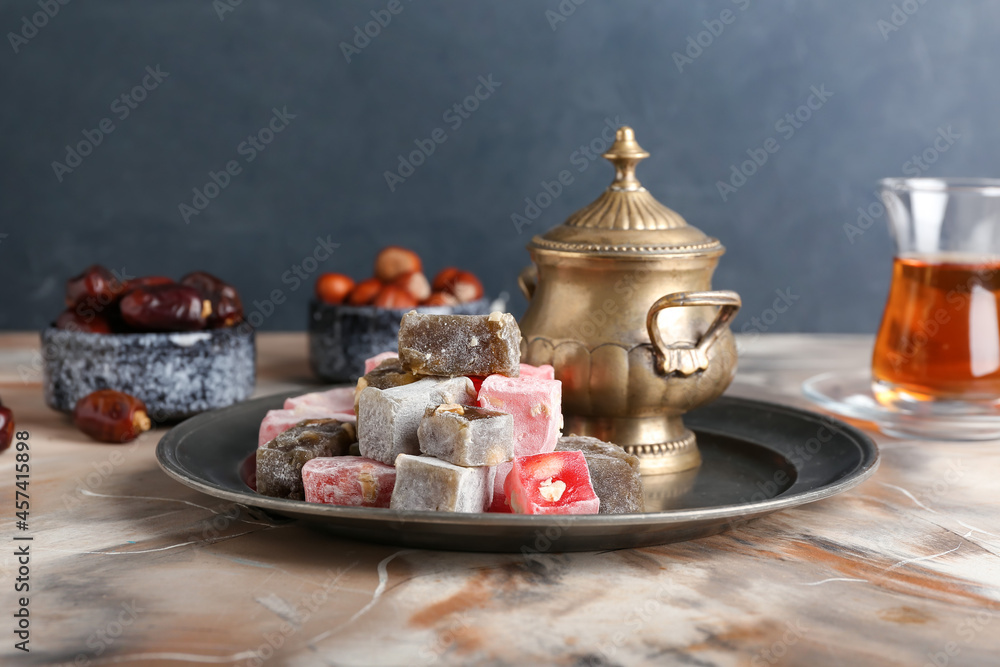 Tray with sweet Turkish delight on table