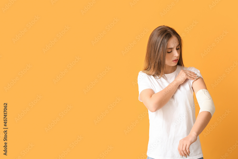 Young woman with bandaged arm on color background Young woman with bandaged arm on color background