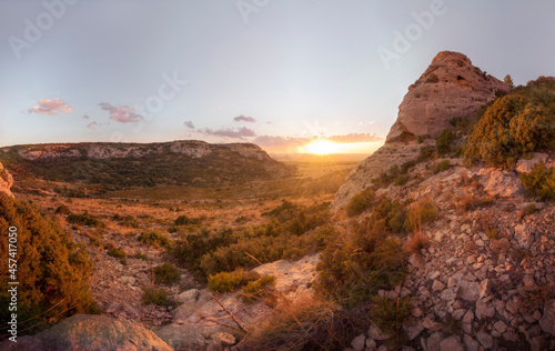 A panoramic view of the sunset. Mountain landscape and meadow at sunse