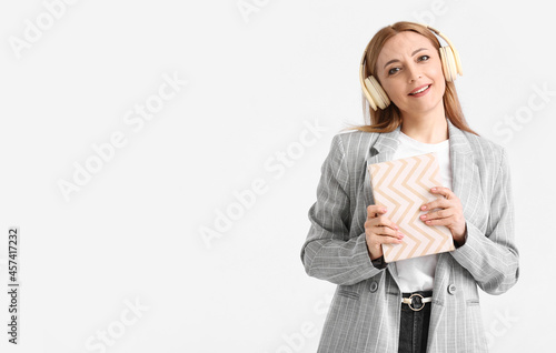 Mature woman with headphone...