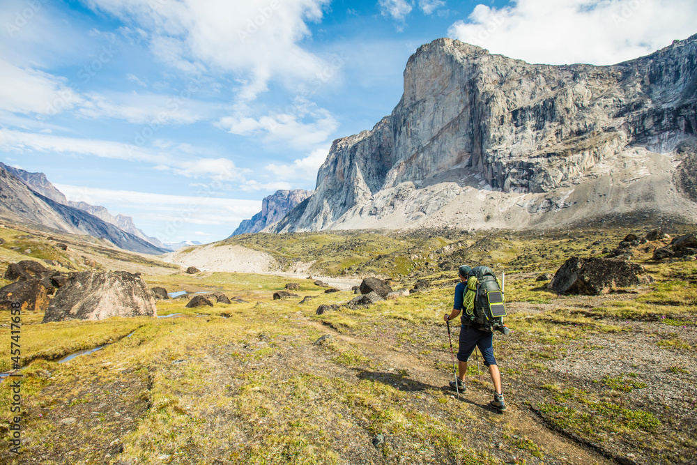 Backpacking in mountains, using solar panel to charge devices. Backpacking in mountains, using solar panel to charge devices.