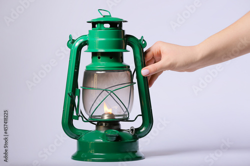 Female hand and retro lamp ...