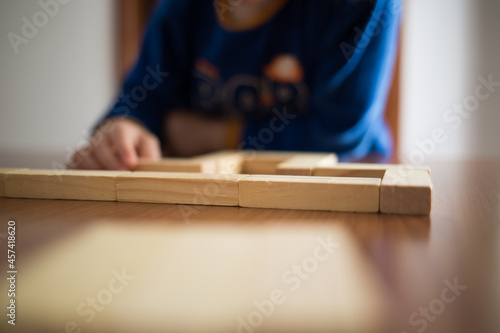 Child playing with Wooden buildings