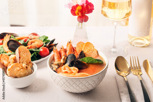 Bowl with tasty Cacciucco soup on table photo