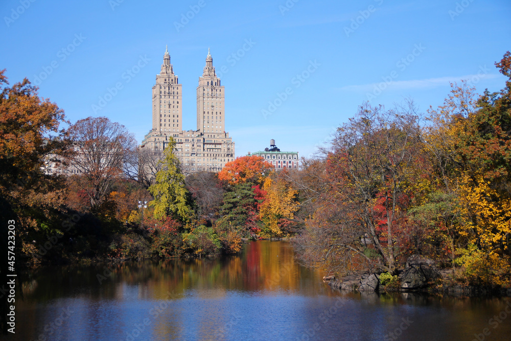 Foliage season in Central Park with the lake and the building on the back
