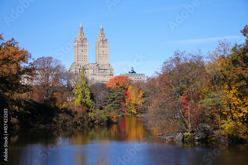 Foliage season in Central Park with the lake and the building on the back