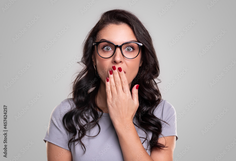 Surprised woman covering mouth with hand Surprised woman covering mouth with hand
