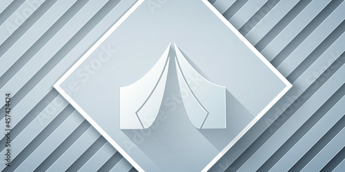 Paper cut Tourist tent icon isolated on grey background. Camping symbol. Paper art style. Vector