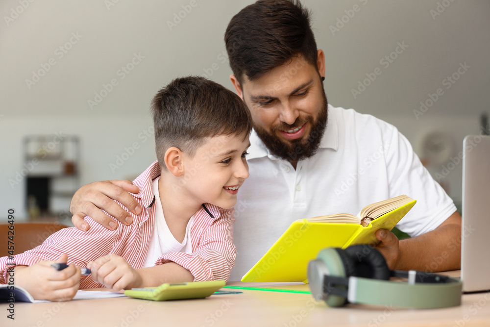 Little boy with his father doing lessons at home Little boy with his father doing lessons at home