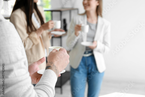 People having coffee break in office