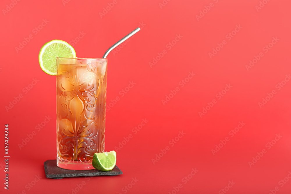 Fototapeta premium Glass of tasty Long Island iced tea on color background