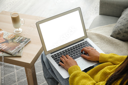 Woman using laptop at home