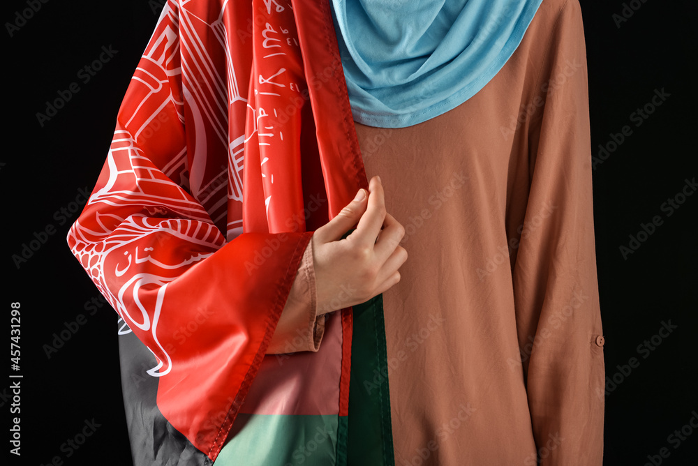 Fototapeta premium Woman with flag of Afghanistan on dark background