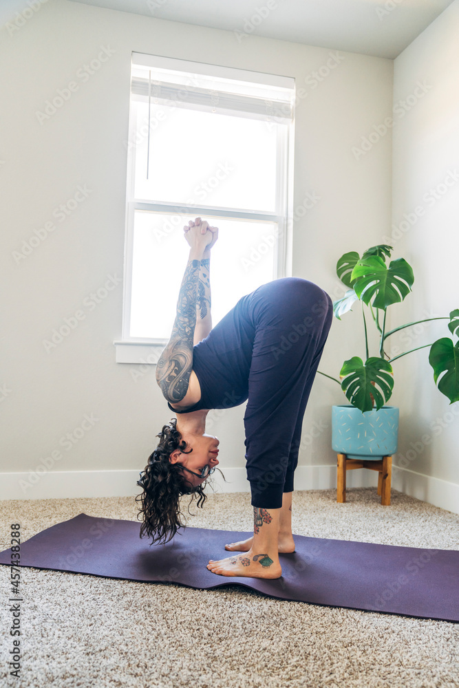 Woman in standing yoga pose at home Woman in standing yoga pose at home