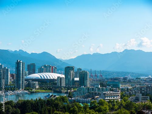 Skyline of the city of Vancouver with Canadian Rocky Mountains to rear of image