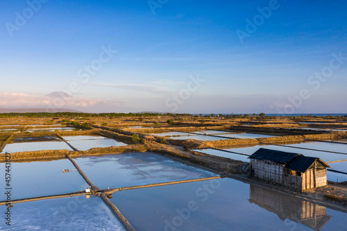 Aerial drone view of large salt fields located on the northern coast of Bali in Pemuteran coastal town to be precise and situated near the ocean to collect the water from the sea. © Joakim