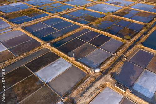 Abstract aerial drone view showing details of salt fields parcels and located on the northern coast of Bali in Indonesia.