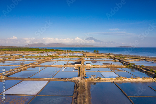Aerial drone view of large salt fields located on the northern coast of Bali in Pemuteran coastal town to be precise and situated near the ocean to collect the water from the sea.