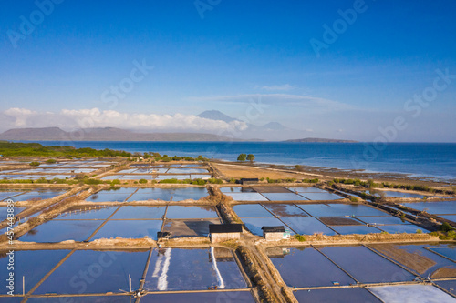 Aerial drone view of large salt fields located on the northern coast of Bali in Pemuteran coastal town to be precise and situated near the ocean to collect the water from the sea. photo