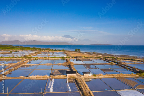 Aerial drone view of large salt fields located on the northern coast of Bali in Pemuteran coastal town to be precise and situated near the ocean to collect the water from the sea.