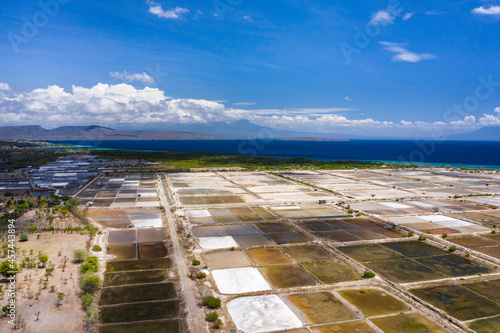 Aerial drone view of large salt fields located on the northern coast of Bali in Pemuteran coastal town to be precise and situated near the ocean to collect the water from the sea.