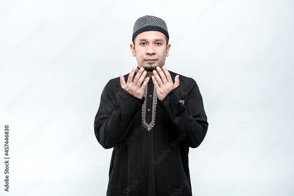 Asian Muslim men are praying with faithful faces and following Islamic practices, on white background, with copy space. Asian Muslim men are praying with faithful faces and following Islamic practices, on white background, with copy space.