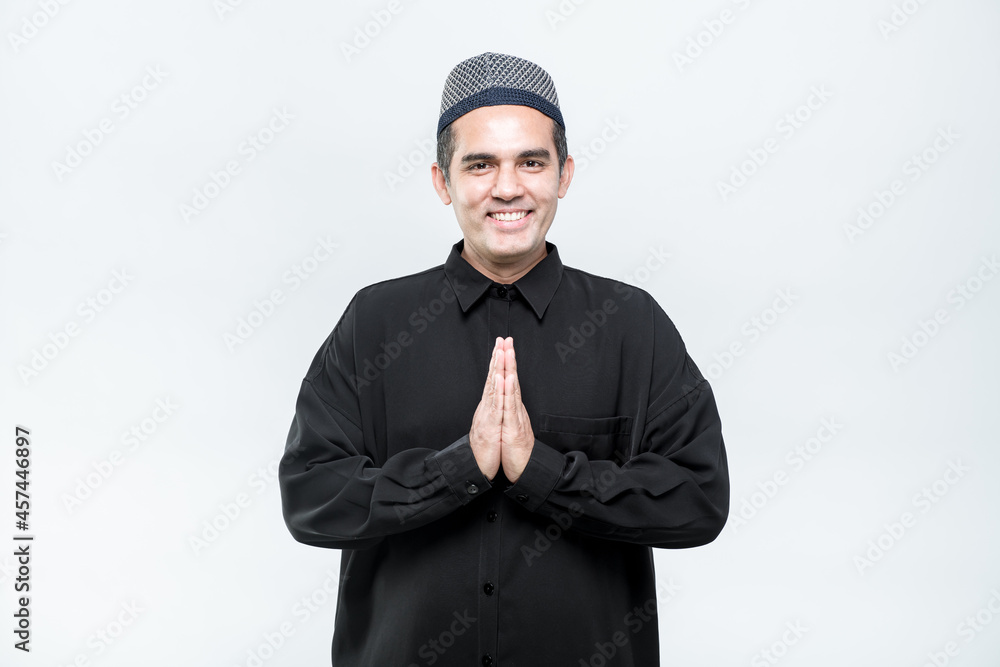 Asian Muslim men standing, hello, greeting with a smiley face, on white background. Asian Muslim men standing, hello, greeting with a smiley face, on white background.