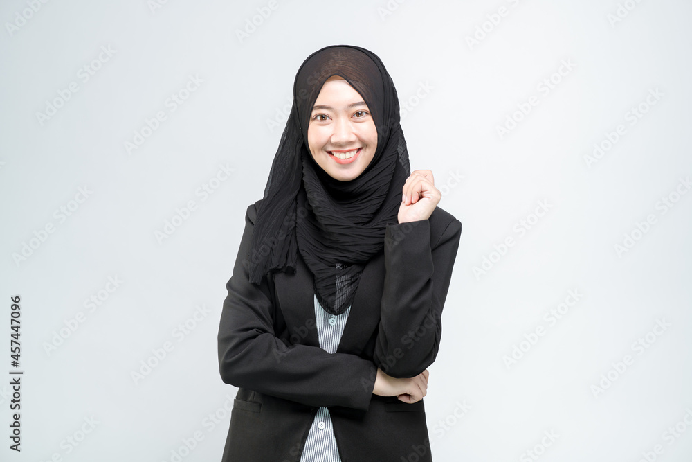 An office worker for an Asian Muslim woman stands with a happy face and a commitment to work, on white background. An office worker for an Asian Muslim woman stands with a happy face and a commitment to work, on white background.