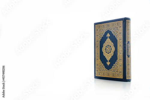 Islamic concept - The Holy Al Quran with written Arabic calligraphy meaning of Al Quran, Arabic word translation: The Holy Al Quran (holy book of Muslim), on white background, with copy space.