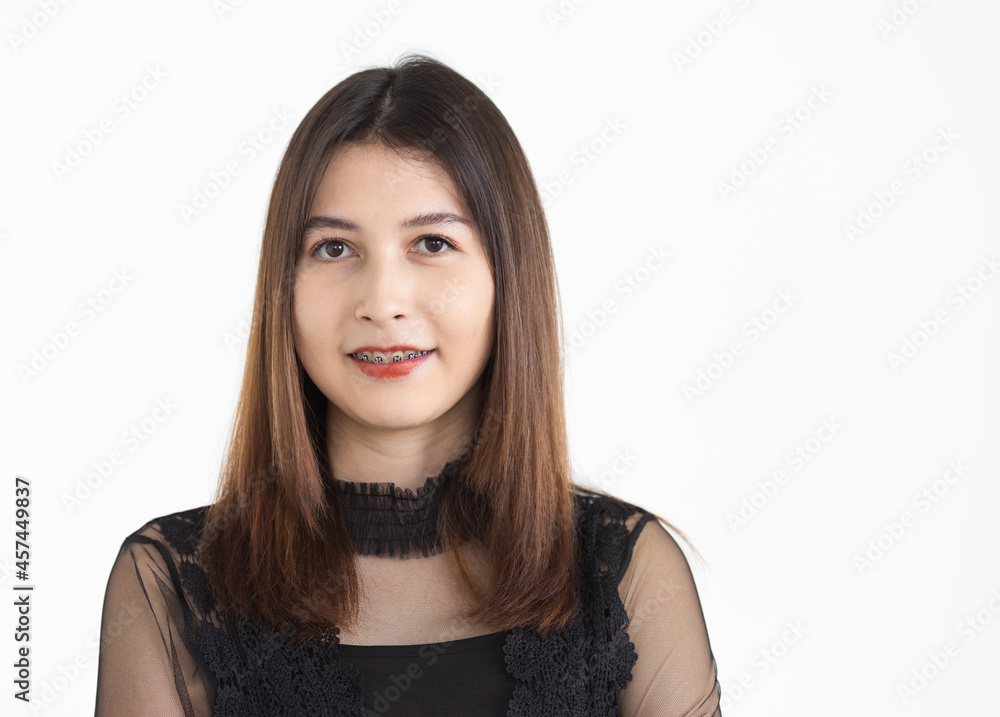 Portrait of young attractive Asian woman with brown hair wearing black revealing dress smiling with confident. Isolated Portrait of young attractive Asian woman with brown hair wearing black revealing dress smiling with confident. Isolated