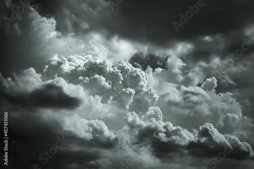 Gray stormy cumulus clouds. Gloomy cloudy sky background with copy space for design. Dramatic cloudscape.