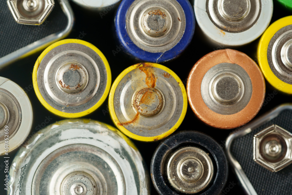 Close up top view of used battery. lot of AA batteries. Electronic hazardous waste, recycling concept Close up top view of used battery. lot of AA batteries. Electronic hazardous waste, recycling concept